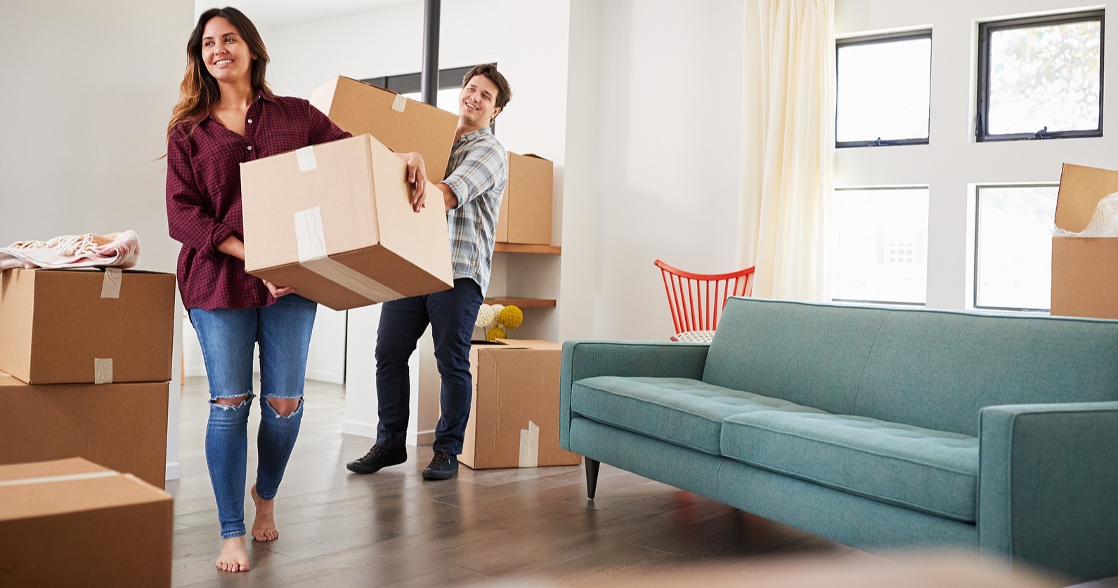 bigstock-Excited-Couple-Carrying-Boxes--251226727